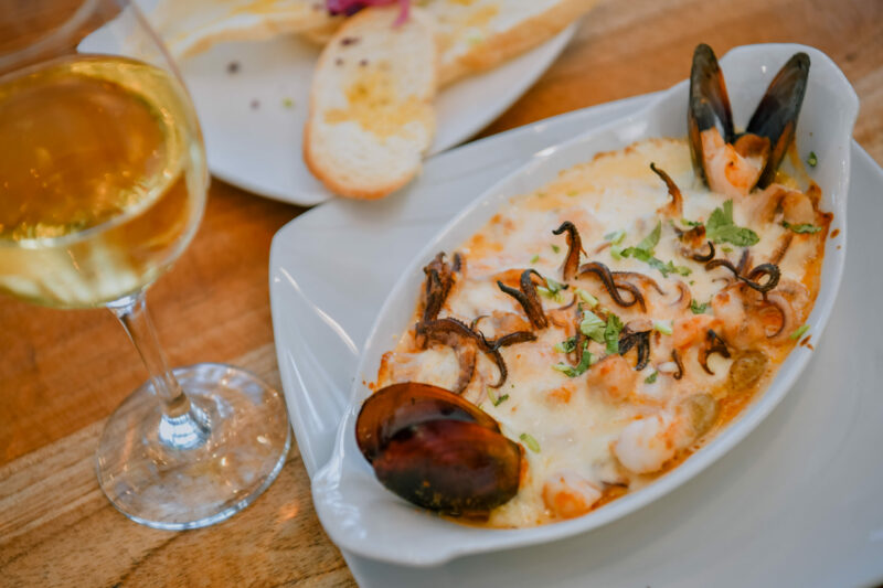 Deliciosa cama de papas babys con filete de pescado, camarones, calamar y almejas aromatizada con vino blanco bañados de queso mozarella con crema, que al gratinar hace una sinfonía de sabores.